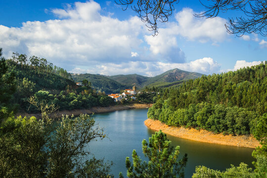 Picturesque village of Dornes in the Zezere river - Portugal. Old church and castle over the river with mountain background