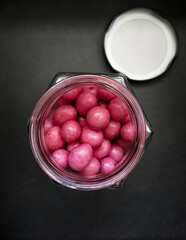 Rose petal flavored chocolate balls in jar, Pink ball chocolates wallpaper.