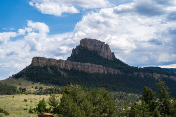 Mountain peak, trees, and a grassy valley just off the Chief Joseph Highway in Wyoming near the...
