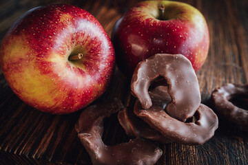 Winter apple with chocolate apple rings on dark wood. Close-up with sweetes for winter and...