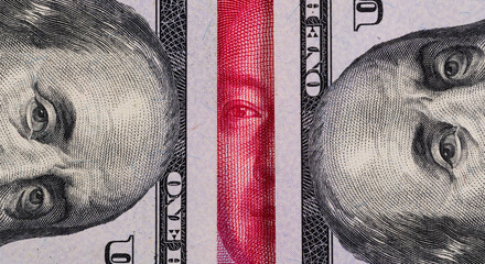 Overlapping fragmentary 100 Chinese yuan and 100 US dollar bills