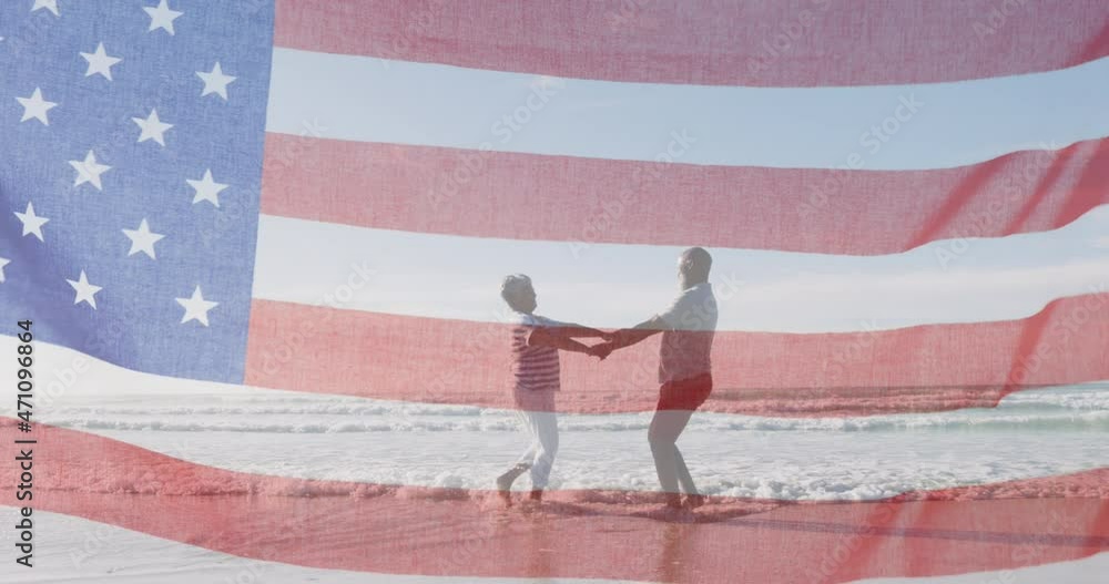 Wall mural Animation of flag of united states of america over happy senior couple dancing on beach by sea