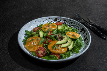 Avocado, orange and cherry tomato salad