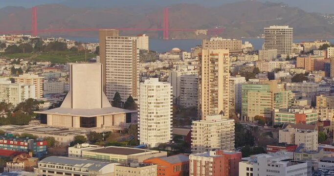 Aerial flying over San Francisco City at sunrise, nob hill, cathedral hill & golden gate bridge