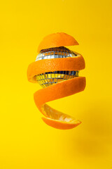 orange peel around a disco mirror ball, floating on yellow background