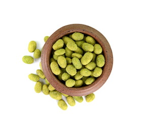 Pile of wasabi coated peanuts in a bowl isolated on white. Top view.