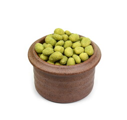 Pile of wasabi coated peanuts in a bowl isolated on white. Top view.