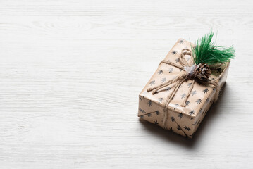 A small festive gift box on the white wooden table background with copy space.