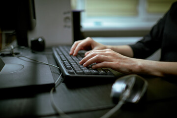 Female hands or woman office worker typing on the keyboard