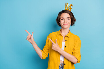 Photo of promoter prom queen lady direct fingers empty space wear crown yellow shirt isolated blue color background