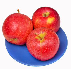Three red apples on a blue plate