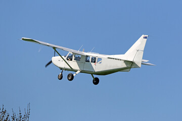 	
Ultralight airplane flying in a blue sky	