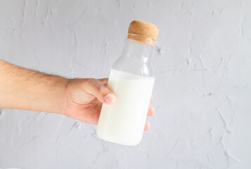 Man holding bottle of yogurt, kefir, soured milk or sour cream