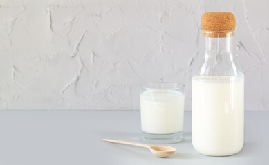 Jar of organic yogurt or kefir with glass and spoon