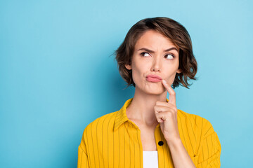 Photo of serious focused uncertain lady look empty space finger chin wear yellow shirt isolated...