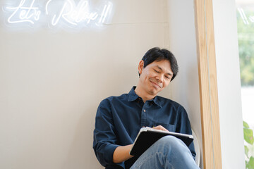 asian freelancer man during creative and draw digital graphic by use tablet with happiness feeling 