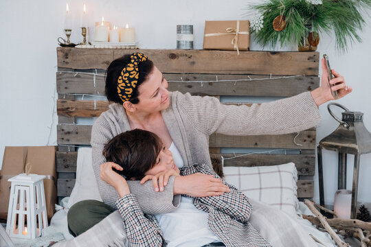 Candid happy family having fun together mother with son taking phoros on mobile. Family. online contratulations.