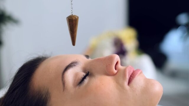 Video of beautiful young woman having reiki healing treatment in health spa center