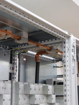 Copper busbar for protective grounding in the electrical panel.