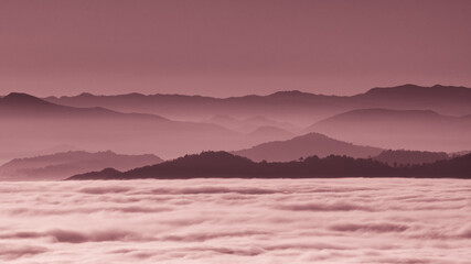 Mountains in succession that emerge from the fog seen from Monte delle Cesane in the province of...