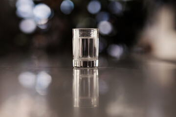 Vodka in glasses on a bar, cold strong drink in a misted glass.
