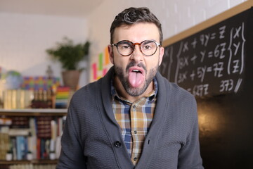 Angry teacher sticking tongue out