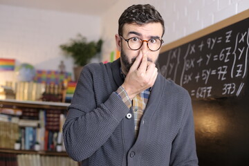 Academic worker smelling something unpleasant