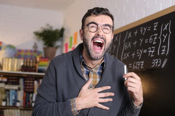 Hilarious teacher laughing out loud in classroom