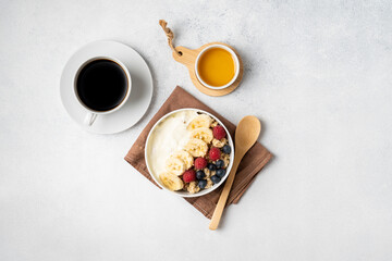 Obraz na płótnie Canvas Morning served breakfast set: pancakes, porridge, cottage cheese, granola, muesli, orange juice, tea, coffee, fruits and berries.
