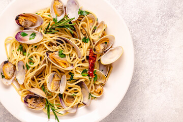 Seafood pasta with clams Spaghetti alle Vongole on a light background