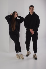 Couple posing in studio wearing black hoodie - 471112093