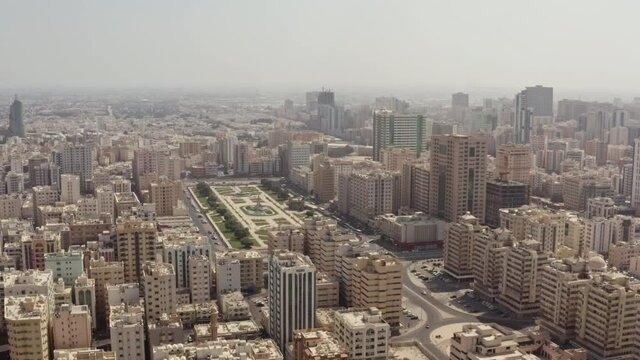 Aerial view Sharjah UAE. Urban cityscape in the desert with high-rise buildings by road cars. With new Arabic architecture.