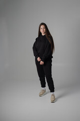 Woman posing in studio wearing black hoodie - 471115652