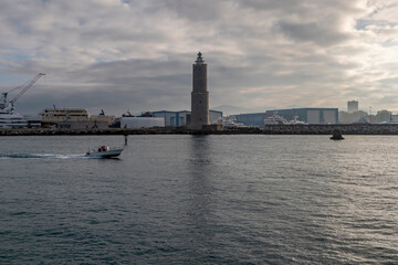 A motorboat near the lighthouse of the ancient Medici port of Livorno, Italy
