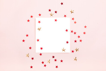 Pink glitter background with sparkles in the shape of stars with copy space, white blank. Layout with space for text with red and gold stars on a pink background.