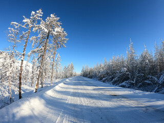 Obraz premium Straight empty asphalt automobile road Kolyma, Yakutia, Russia, travel concept