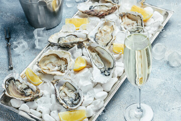 Fresh oyster in dish with lemon and champagne in restaurant. banner, menu, recipe place for text,...
