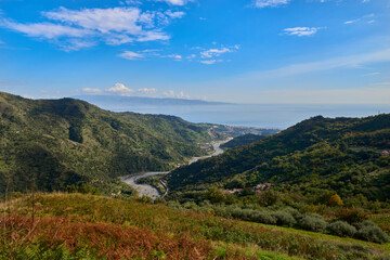 Fototapeta na wymiar the Savoca stream runs through the valley and flows into the Ionian sea of the Strait of Messina on a beautiful sunny day in Autumn