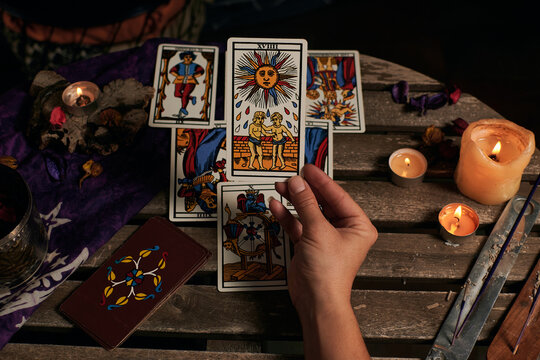 Close-up of a fortune teller reading tarot cards