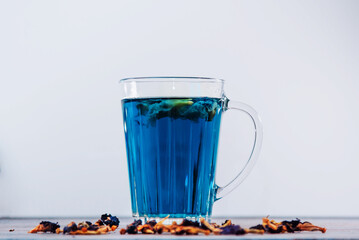 Organic Butterfly pea flowers blue Anchan tea in a glass mug. Detox healthy drink.