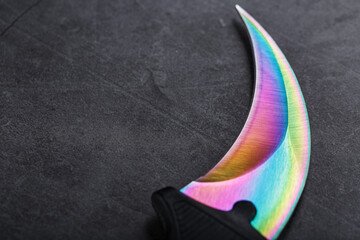 A dagger with a steel blade with a gradient color on a black background.