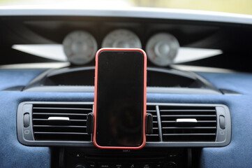Smartphone mounted on dashboard during a daytime drive