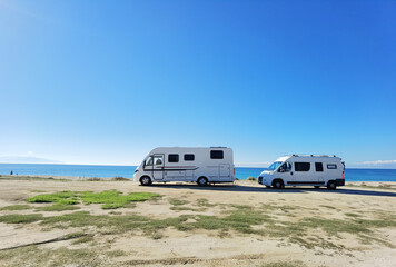 caravans cars beside sea beach in autumn greece