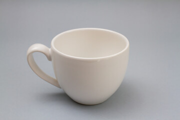 empty new white cup on gray background