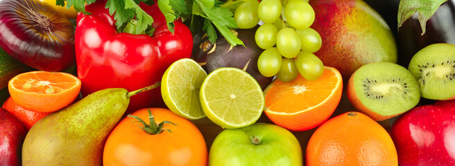 Bright background from vegetables and fruits. Wide photo.