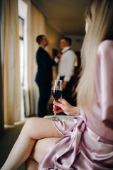 the bride holds a glass of delicious champagne