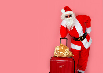 A modern Santa Claus with a suitcase and a bag of gifts is waiting for a plane to go on a trip to give gifts to children