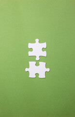 pieces of a puzzle represent the compatibility between two people or ideas. vertical image with copy space, text space