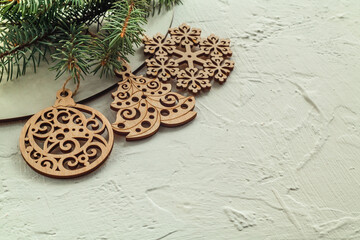 Wooden Christmas toys and fir tree branches on a white background. Copy space.
