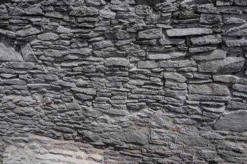 Texture of a stone wall. Old castle stone wall texture background. Stone wall as a background or texture. Part of a stone wall, for background or texture